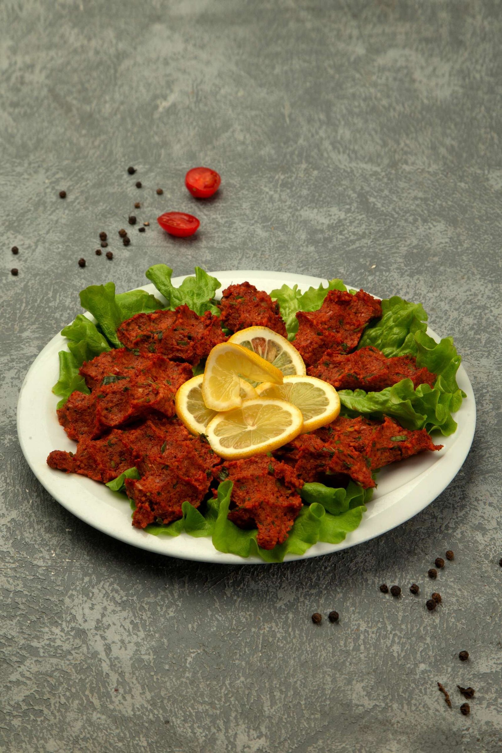 plate turkish chig kofte raw meatball with tomato paste spice 1 scaled